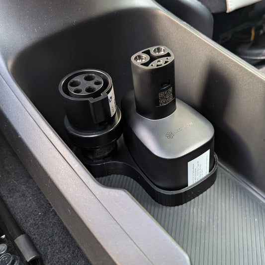 Car cup holder with two charging devices inside a vehicle.